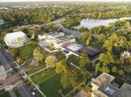 Aerial view of the museum's campus, including a rendering of the new Gundlach Building, Great Lawn, and indoor Town Square covered by Olafur Eliasson and Sebastian Behmann's Common Sky.