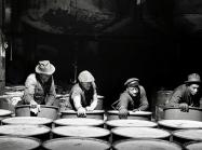 "Workmen stacking drums of grease ready for shipment.", March 1944