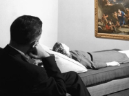 woman on therapist couch looks at painting on wall