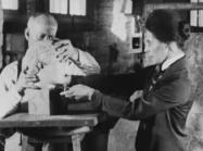 Two met workers from the 1920s adjust the head of a sculpture