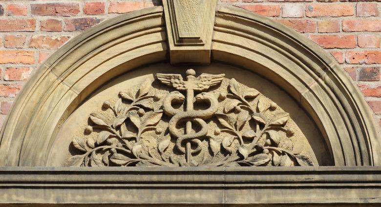 caduceus symbol above a doorway