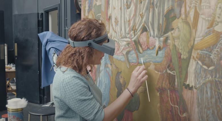 Conservator works on altarpiece