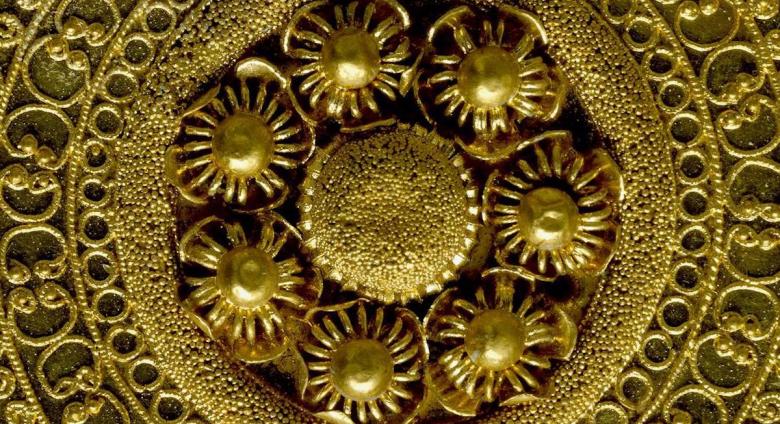Detail shot of a gold ear-stud: disc decorated with granulation, filigree and beaded wire. 530BC-500BC