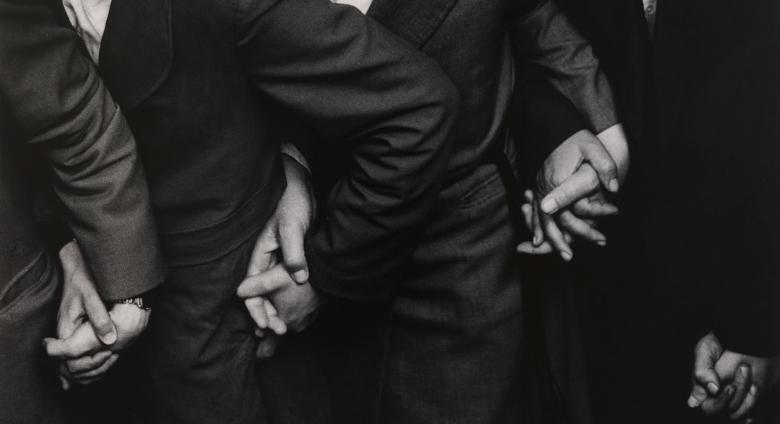 Ken Heyman black and white photograph of four sets of hands holding eachother