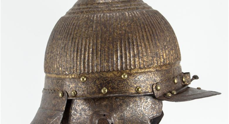 metal helmet with front and back bills, ear flaps and pointed top
