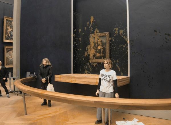 Protesters from the group Riposte Alimentaire after splashing pumpkin soup on the Mona Lisa.