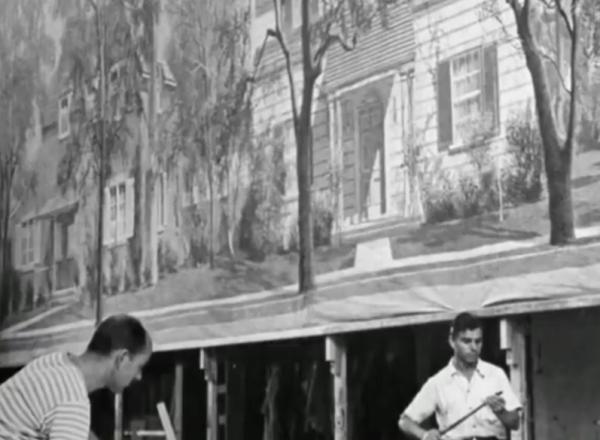 Men work on move backdrop, black and white image